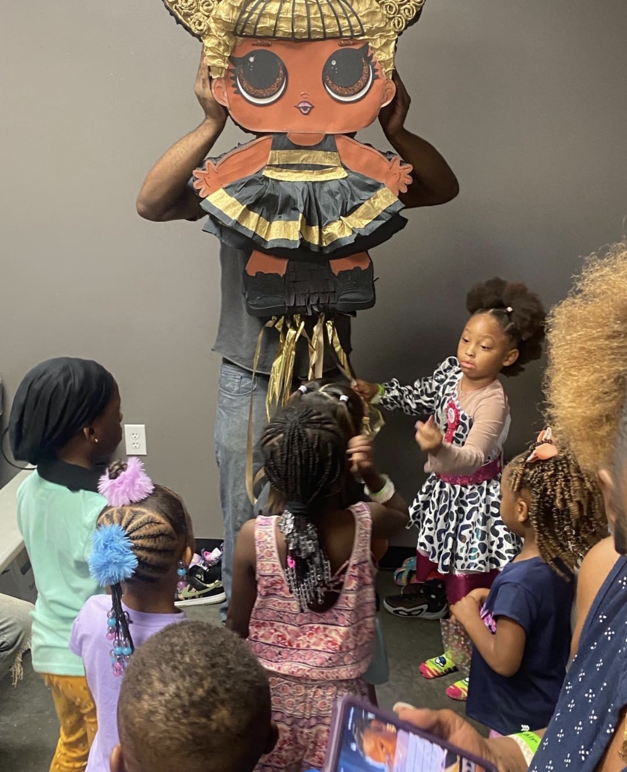 LOL Surprise doll piñata at a party