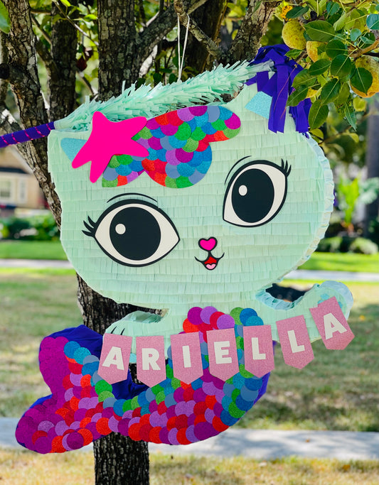 Make a splash with our handmade Mermaid Cat Piñata! Perfect for Mercat or Meow-maid birthdays. Custom names and colors available. Order for US shipping or Houston pickup.