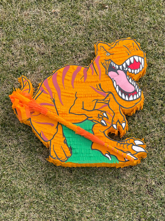 Handmade orange T-Rex dinosaur piñata for kids birthday party
